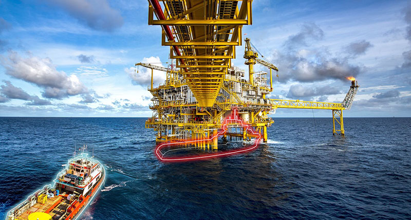 Offshore support vessel approaching an oil rig, colourful outlines symbolize how spoofing could make the positioning officer collide with the rig.